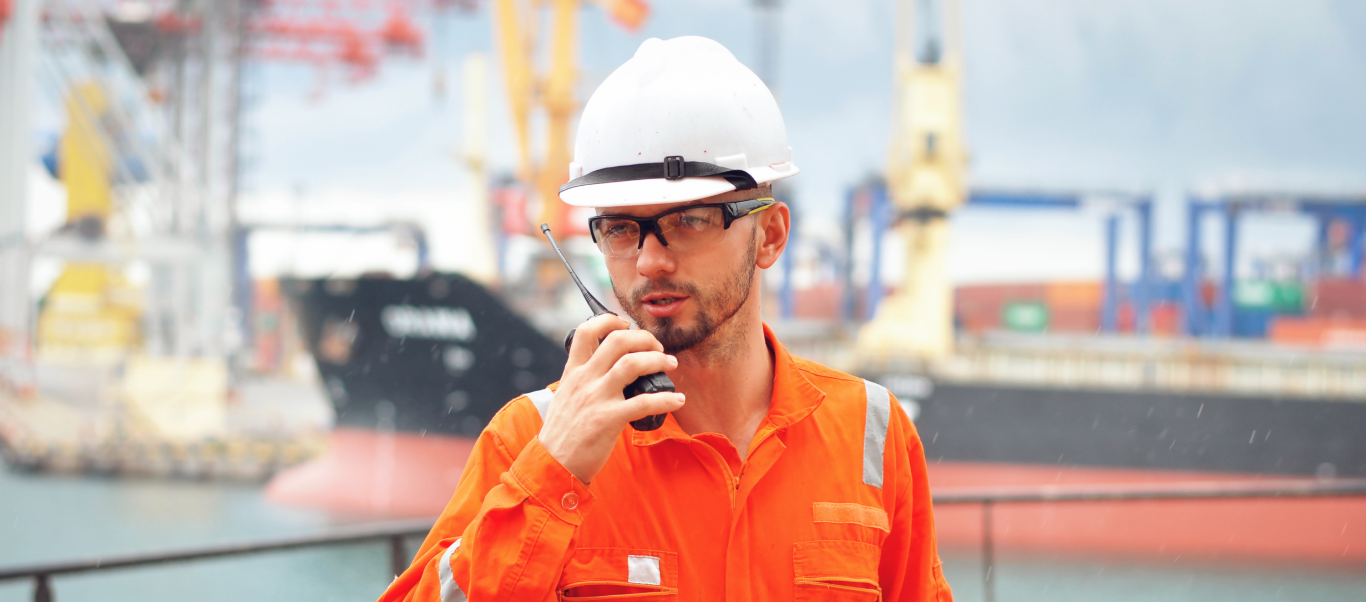 Man on a ship holding a radio